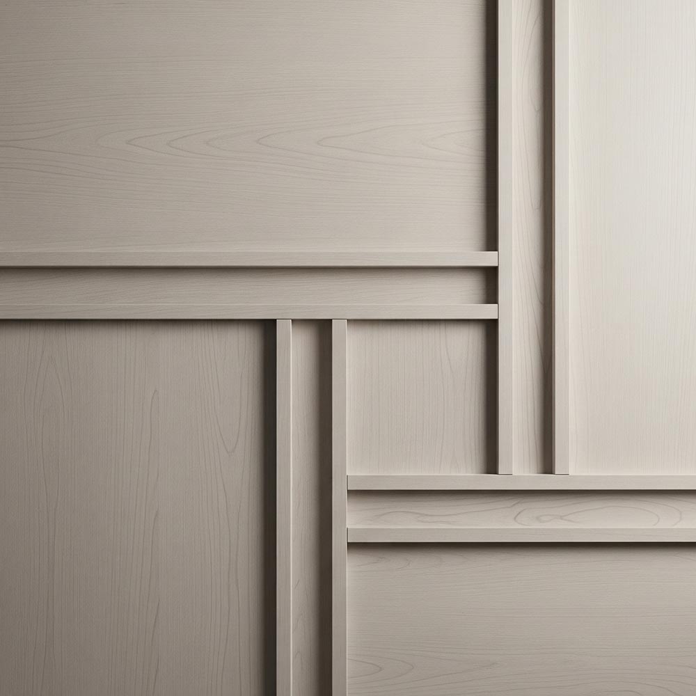 Precision millwork forms a square pattern on a wall panel.